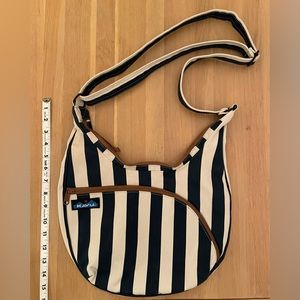 Navy blue striped cross body Kavu bag with brown zipper and gold interior